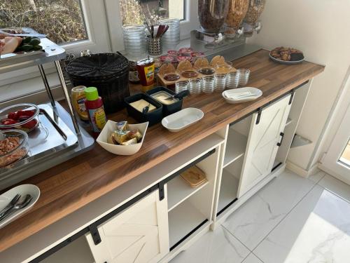 a kitchen with a counter with food on it at Designapartments Business and More - Sennhütte 9 in Wernigerode