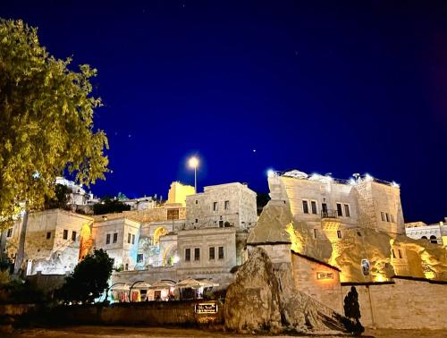 a group of buildings at night at Tafoni Houses Cave Hotel in Ortahisar