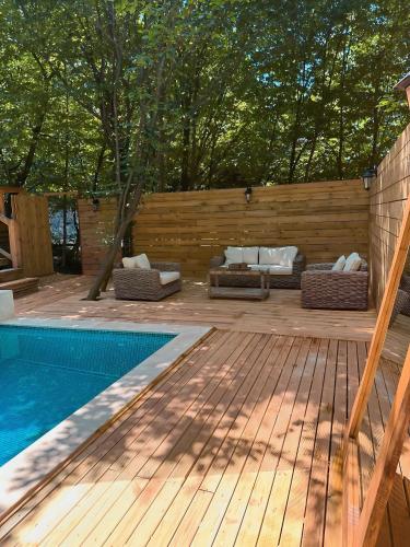 a backyard with a swimming pool and a wooden deck at Chalet Sapanca in Sakarya