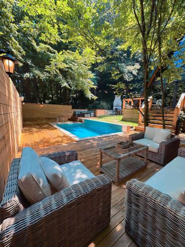 a patio with wicker furniture and a swimming pool at Chalet Sapanca in Sakarya