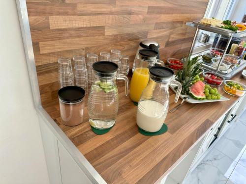 a counter with bottles of milk and a plate of food at Designpension Idyll Nr21 Hotel Garni in Wernigerode