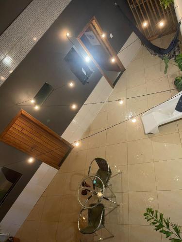 a room with two chairs and a ceiling with lights at Santa Onda Itacaré in Itacaré