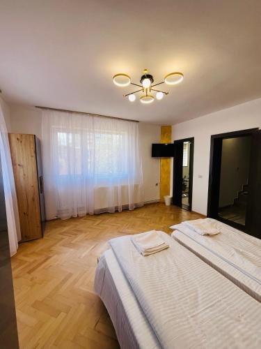a bedroom with two beds and a ceiling fan at Random House in Braşov