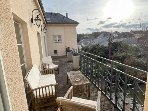 einen Balkon mit Stühlen und einem Tisch auf einem Haus in der Unterkunft Versailles, quartier Saint Louis in Versailles