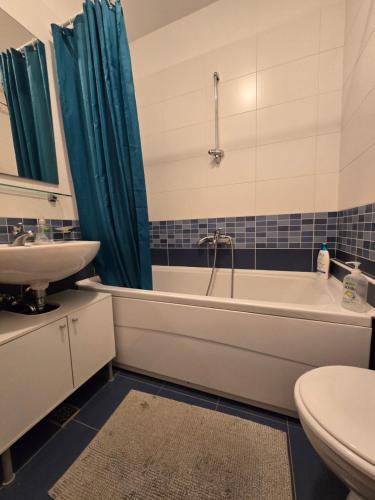 a bathroom with a tub and a sink and a toilet at Apartman ured Tanja, Iver in Sesvete