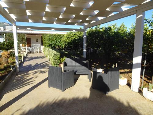 a patio with a pergola with potted plants at Casa Vacanza Villa Giovanna in Valderice