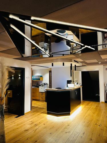 an empty room with a kitchen and a loft bed at Genusshotel Diamant in Naturno