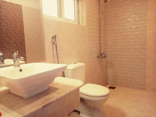 a bathroom with a white sink and a toilet at Royal Galaxy Bed & Breakfast E-11 Islamabad - For Families Only in Islamabad