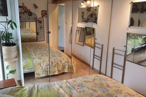 a room with two beds in a room with mirrors at Chambre atypique avec miroirs ds Logement entier in Villeurbanne