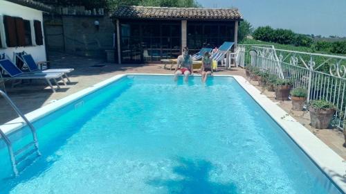 two children are sitting in a swimming pool at Civettina in Senigallia