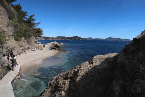 Un groupe de personnes marchant sur une plage près de l'eau dans l'établissement Mourillon appartement T2/ 2 *, à Toulon