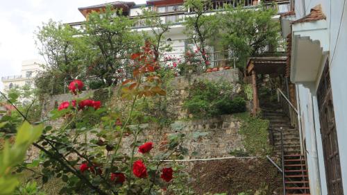 a stairway with red flowers on the side of a building at May Nui Sa Pa Hostel in Sa Pa
