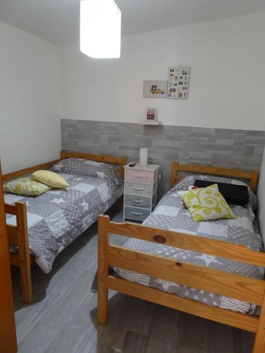 a bedroom with two beds and a night stand at Casa Vacanza Villa Giovanna in Valderice