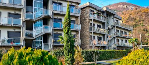 an apartment building with balconies and trees at Residence Alessandra Supervacanza - Domaso in Domaso