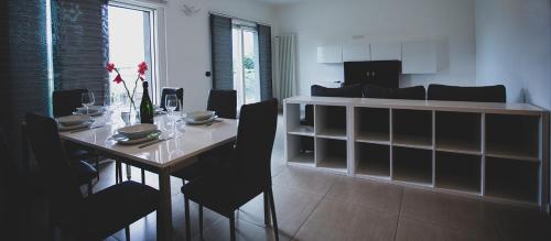 a dining room with a table and chairs in a room at Residence Alessandra Supervacanza - Domaso in Domaso