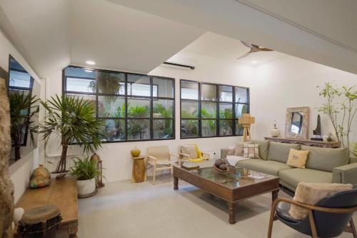 a living room with a couch and a table at Rwanda Naziza - Private Villa in the Old Town City - PRIME LOCATION I Daily Housekeeping in Chiang Mai