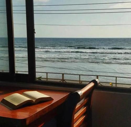 ein offenes Buch auf einer Bank mit Blick auf den Ozean in der Unterkunft Suite frente al mar - CIELO in Montañita