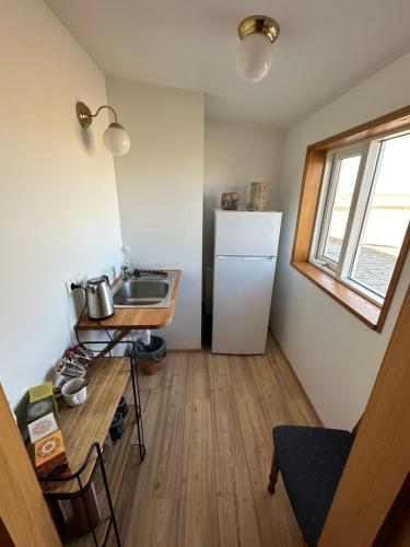 a small kitchen with a sink and a refrigerator at Helja Stay Glamping Domes in Hella