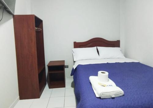 a bedroom with a bed with a roll of toilet paper on it at Hallpa Ica in Ica