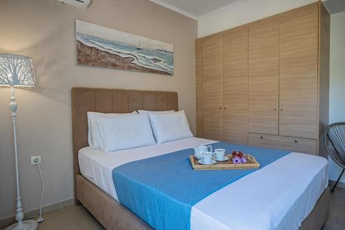 a bedroom with a bed with a tray on it at Luisa Holiday Home in Ádhele