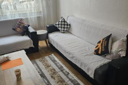 a living room with a white couch with pillows on it at Private Apartment in Hannover