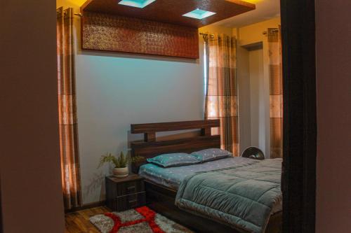 a bedroom with a bed and a large mirror at Suku family house. in Pātan
