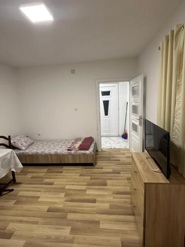 a bedroom with a bed and a flat screen tv at gvero apartment’s in Prilep