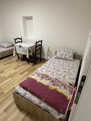 a room with a bed and a table and a table and chairs at gvero apartment’s in Prilep