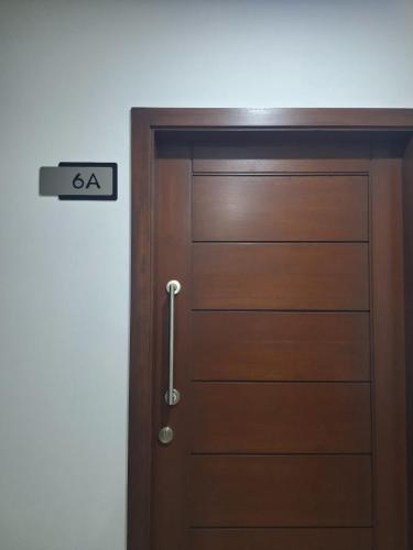 a wooden door with a sign that reads ahead at Depar land tower in Tarija