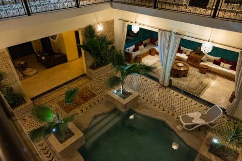 an aerial view of a living room with a swimming pool at Riad Tonaroz in Marrakech
