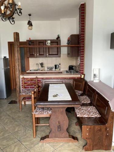 a kitchen with a table and chairs and a counter at Appartamento Ville sur Nus in Quart