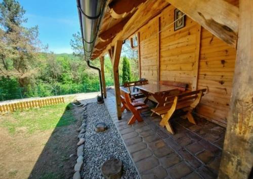 a log cabin with a picnic table in the backyard at Drinska Villa Cabin in Perućac