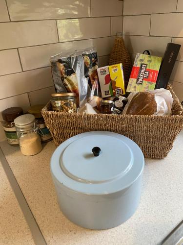 a bowl on a counter with a basket of food at Grooms Cottage next to Sheriff Hutton Castle in Sheriff Hutton