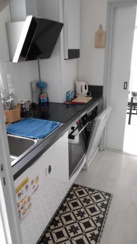 a kitchen with a sink and a counter top at Le Bellevue in Givet