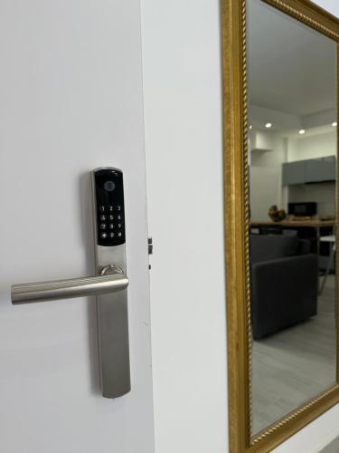 a mirror with a remote control attached to a door at Central Suites Aegina 3 in Aegina Town