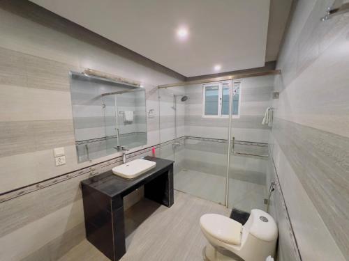 a bathroom with a toilet and a sink and a shower at Family Lodges in Islamabad
