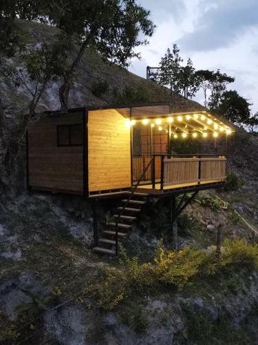 a tiny house on a hill with lights on it at La Peña Cabins - Ebéjico in Ebéjico