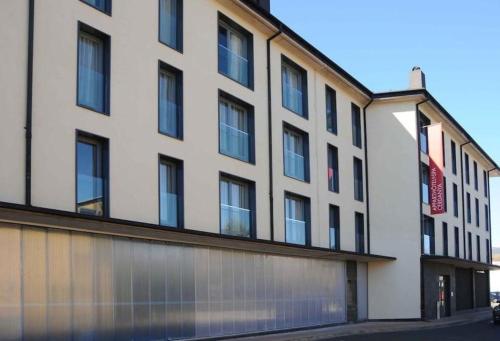 a large white building with a lot of windows at Résidence CERDANYA in Bourg-Madame