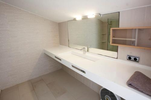 a bathroom with a sink and a mirror at Casa en primera linea en Binibeca Vell in Binibeca