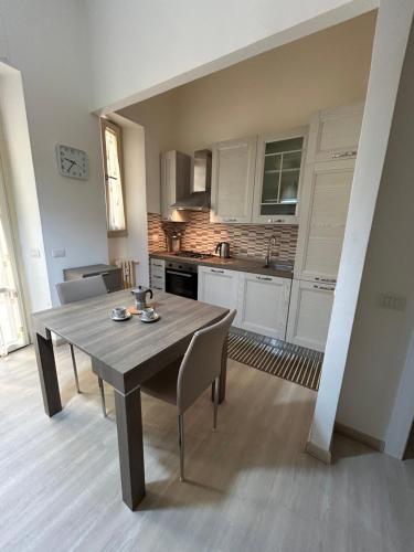 uma cozinha com mesa e cadeiras num quarto em Appartamento incantevole con patio em Florença