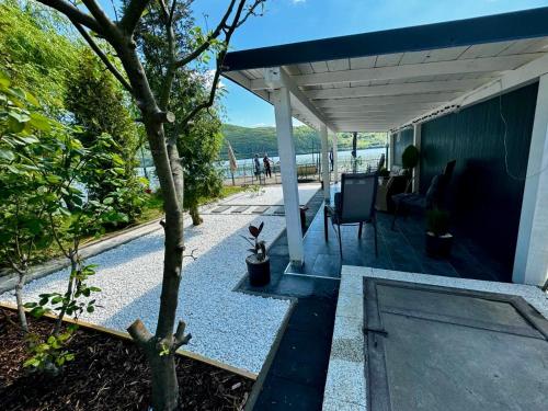 a house with a patio with a tree at Casa Anastasia in Dubova