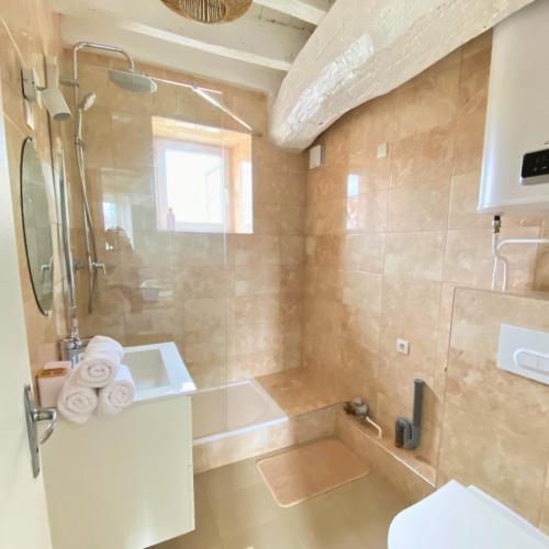 a bathroom with a shower and a tub and a sink at Charmant Studio à Étampes in Étampes