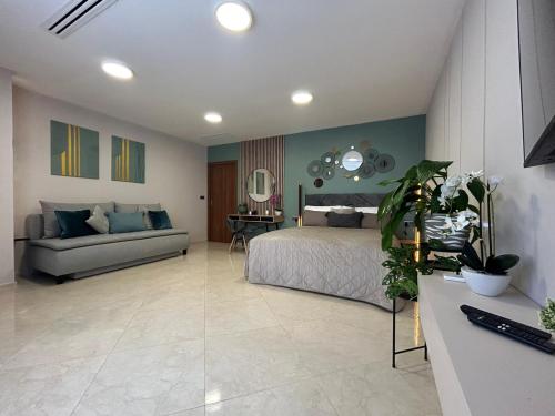 a bedroom with a bed and a couch at LEO Apartment FREE PARKING - President Palace in Bratislava