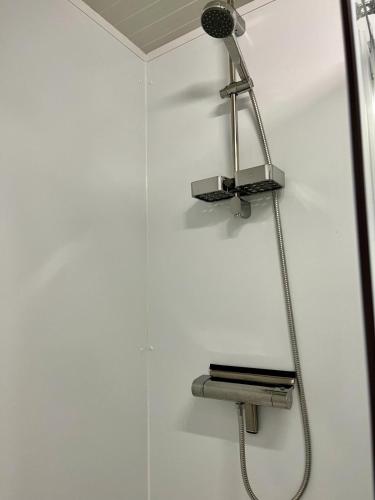 a shower with a shower head on a wall at SPOT Jelsum in Jelsum