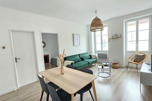 un salon avec un canapé vert et une table dans l'établissement Superbe appartement 2 chambres au coeur de Pau, à Pau