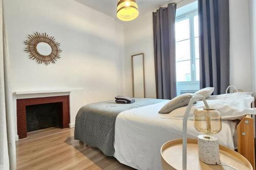 une chambre blanche avec un lit et une cheminée dans l'établissement Superbe appartement 2 chambres au coeur de Pau, à Pau
