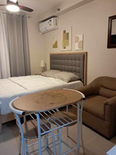 - une chambre avec un lit, une table et un canapé dans l'établissement New Cozy Studio Apartment, à Marigondon