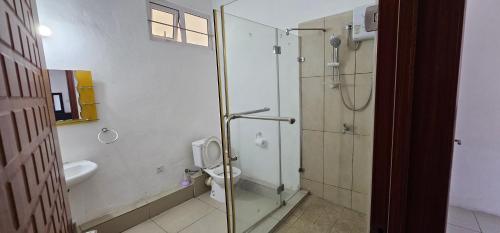 a bathroom with a glass shower and a toilet at Ollier Plaza Apartments in Port Louis