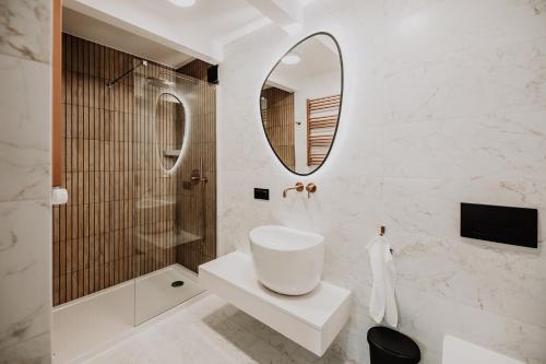 a bathroom with a sink and a mirror at Coś miłego in Gowidlino