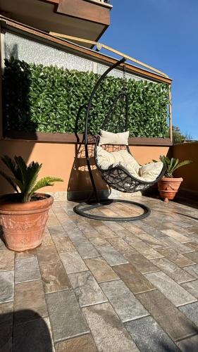 a hammock sitting on a patio with plants at Zefiro Ostia in Lido di Ostia